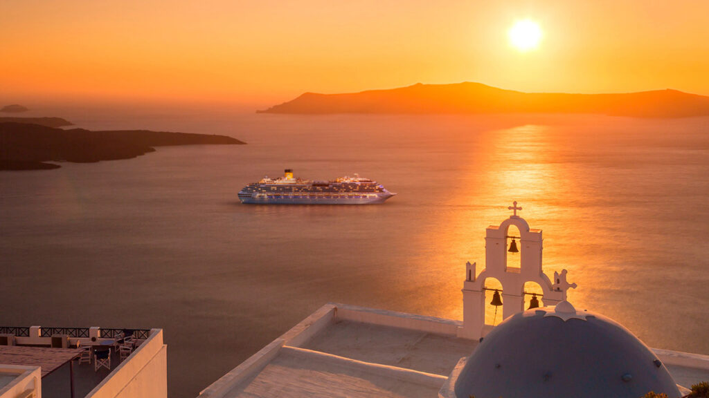 View of a cruise ship from Santorini at dusk.